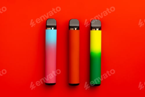 Preview: Disposable electronic cigarettes on red background close up