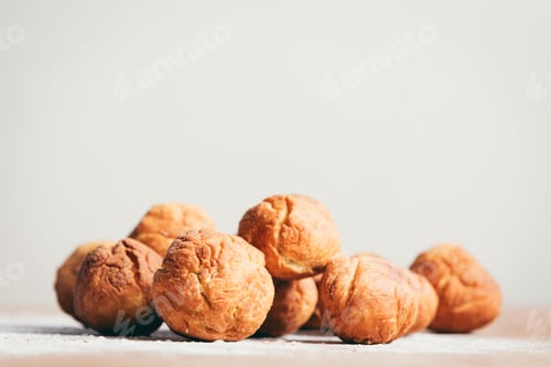 Preview: Bunch of baked donuts laying on the kitchen counter.