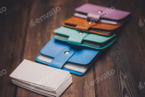 Preview: multicolored business card holders on a wooden background and a pack of white paper Copy Space