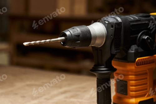 Preview: close-up focus on a strong drill bit for a hammer drill with a strong carbide tip inserted into a