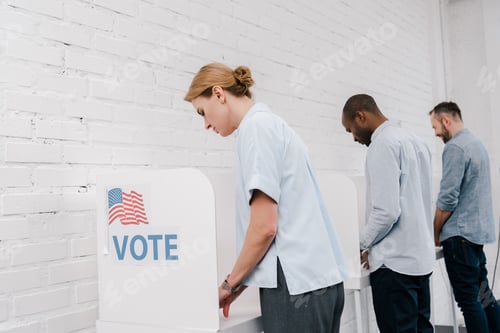 Preview: selective focus of multicultural citizens voting near brick wall