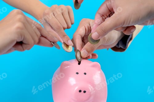 Preview: Hands Putting Coins Into Piggy Bank