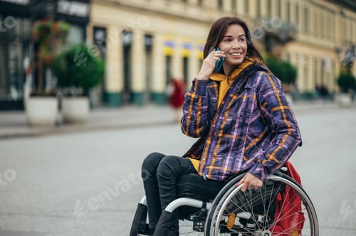 Preview: Woman with disability using a smartphone while out in the city
