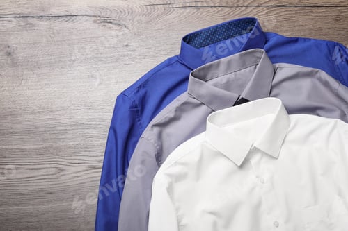 Preview: Three Dress Shirts Laid on Wooden Background
