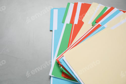 Preview: Many documents in folders on grey table, top view. Space for text