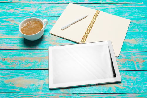 Preview: digital tablet and coffee cup on wooden table