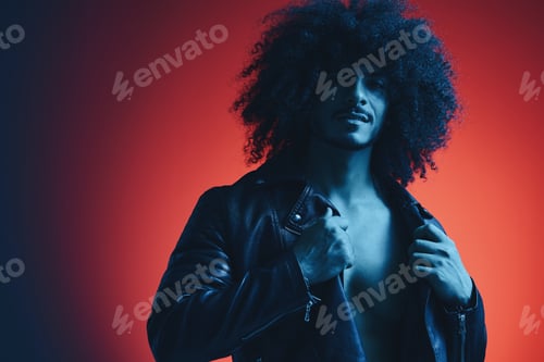 Preview: Portrait of fashion man with curly hair on red background multinational, colored light, black
