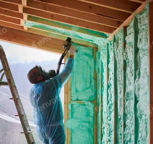 Preview: Worker spraying polyurethane foam for insulating wooden frame house.