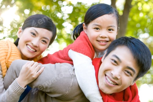 Preview: Young Family Playing in a Park in Autumn