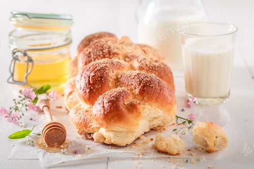Preview: Fresh golden challah with milk and honey.