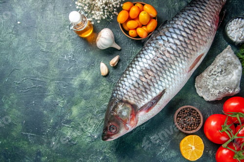 Preview: top view fresh raw fish with kumquats and tomatoes on dark background food health water fish color