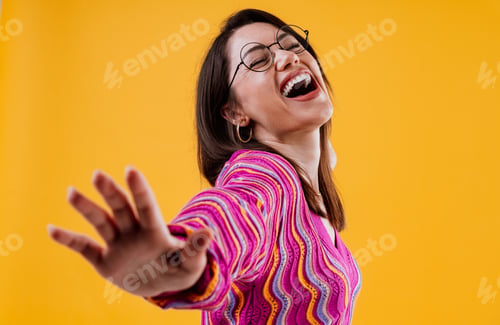Preview: Young woman laughing heartily showing happiness and joy