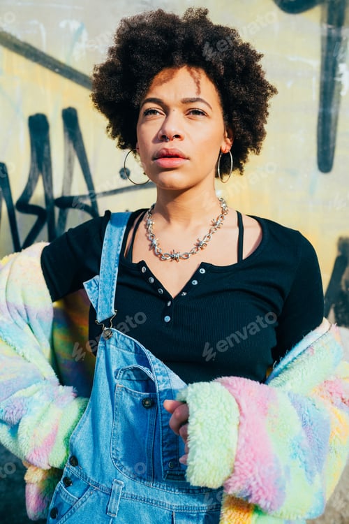 Preview: Young pensive mixed race curly hair woman posing outdoor