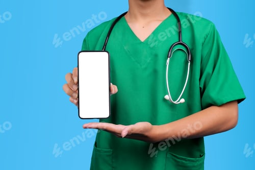 Preview: Doctor in Scrubs and Stethoscope Hold a Smartphone with Blank White Screen Against Blue Background