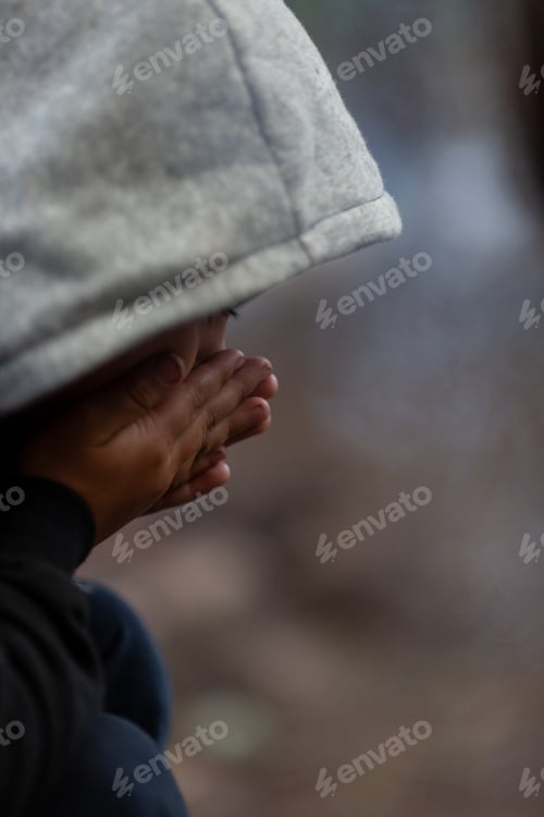 Preview: The boy breathes on his frozen hands