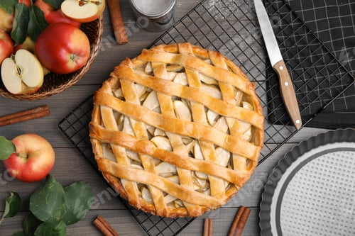 Preview: Delicious traditional apple pie on wooden table, flat lay
