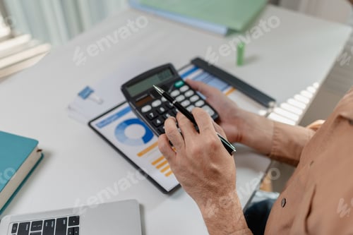 Preview: Person using calculator while reviewing budget report on desk