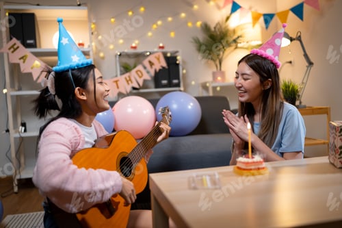 Preview: Two Asian women in room with Ciematic lighting celebrate important events such birthdays Christmas