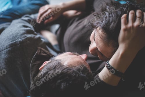 Preview: Couple embracing, face to face, overhead view