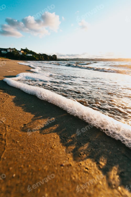 Preview: Super close up of some tides with bubbles in the beach during a super colorful sunshine