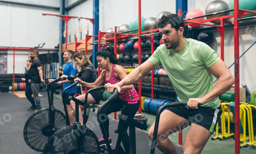Preview: Athletes doing air bike indoor