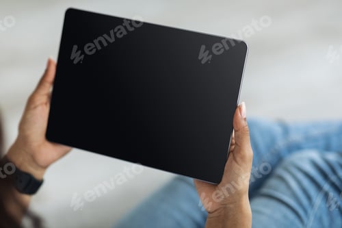 Preview: Black woman holding digital tablet with blank screen mockup for application, website or