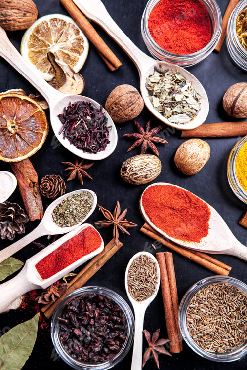 Preview: wooden spoons with spices on black background