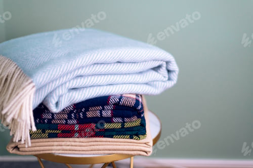 Preview: Stack of woolen checked blankets