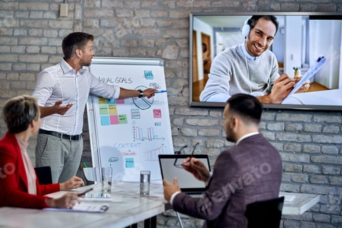 Preview: Group of coworkers having video business conference in the office.