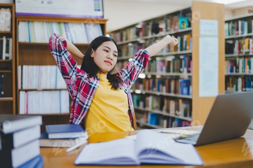 Preview: Students are relaxing after working on their laptops and searching for books