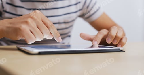 Preview: Man use of tablet computer at home