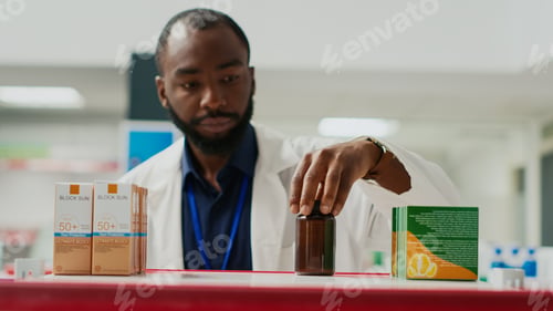 Preview: Drugstore consultant organizing drugs on racks
