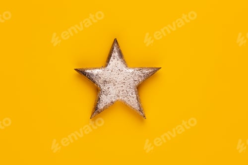 Preview: Christmas star decor on yellow colored background.