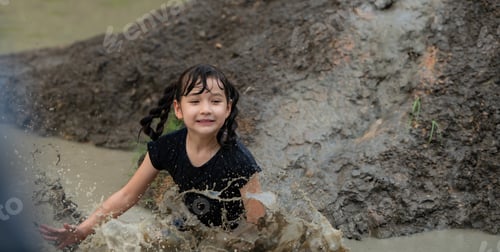 Preview: Little girls have fun playing in the mud in the community fields