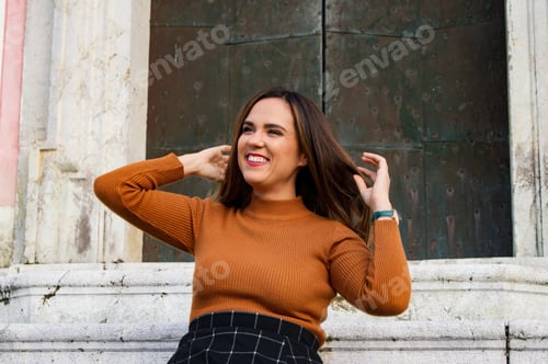 Preview: Smiling Woman With Brown Hair and Orange Sweater
