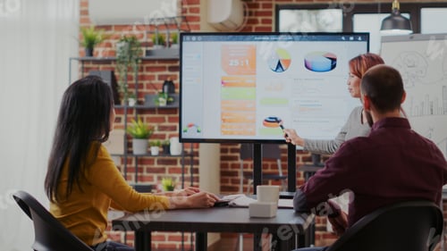 Preview: Business people looking at statistics presentation on screen