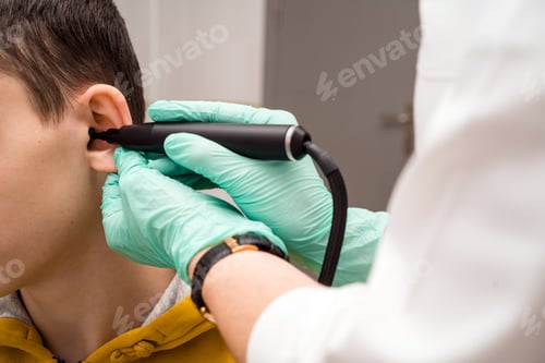 Preview: Preventive inspection of a teenage boy in a medical facility. Otorhinolaryngologist doctor