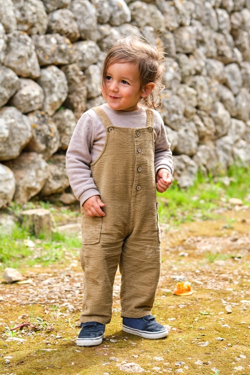 Preview: Cute little girl on rough land in summer