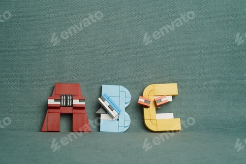 Preview: Miniature figure of the letters ABC against a fabric greenish background