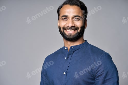 Preview: Smiling indian business man executive isolated on gray, headshot portrait.