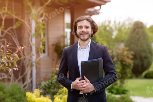 Preview: Portrait of happy real estate agent with documents posing near house outdoors