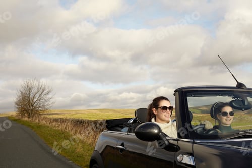 Preview: Women driving in rural landscape