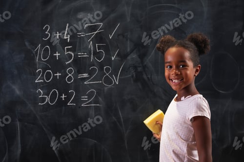 Preview: Schoolgirl doing math on blackboard