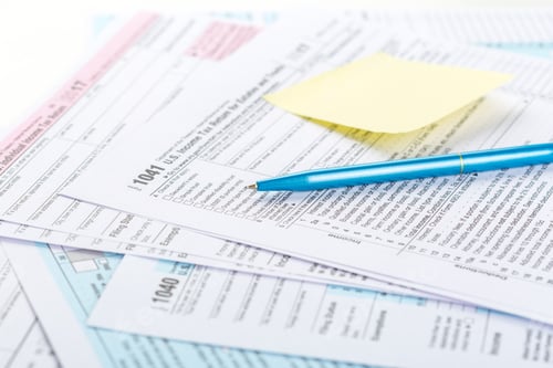 Preview: Tax forms and a pen on a desk in an office setting during tax season