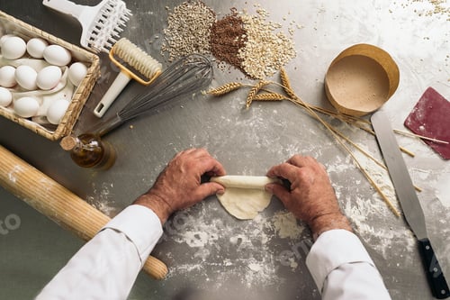 Preview: Baker kneading dough in a bakery.