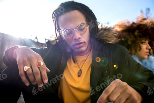 Preview: Portrait of man with dreadlocks looking down