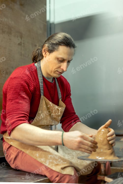 Preview: Master male potter making a vase. Pottery. Clay modeling. Creating ceramics.
