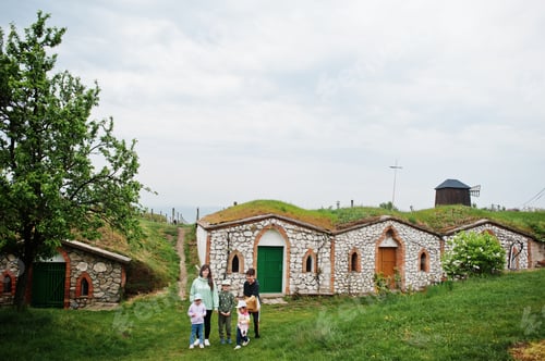 Preview: Mother with kids walking near traditional wine cellars outdoor at Vrbice, Czech Republic.