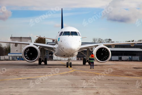 Preview: Passenger plane at the airport background. The plane lands at the international airport. White
