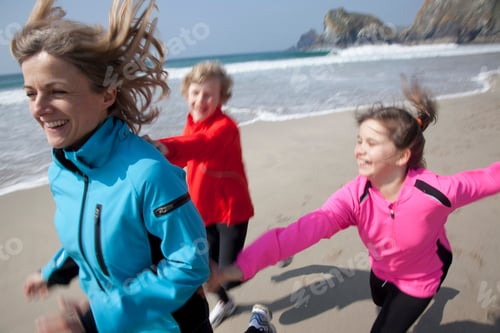 Preview: Mother and children playing on beach